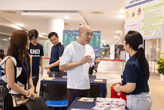 Assistant Prof Aidan Wong in conversation with student